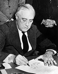 240px Franklin Roosevelt signing declaration of war against Japan1